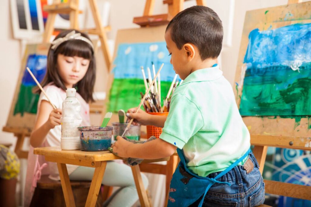 Kids enjoying themselves while painting a picture at an art class near Lexington, Kentucky (KY)